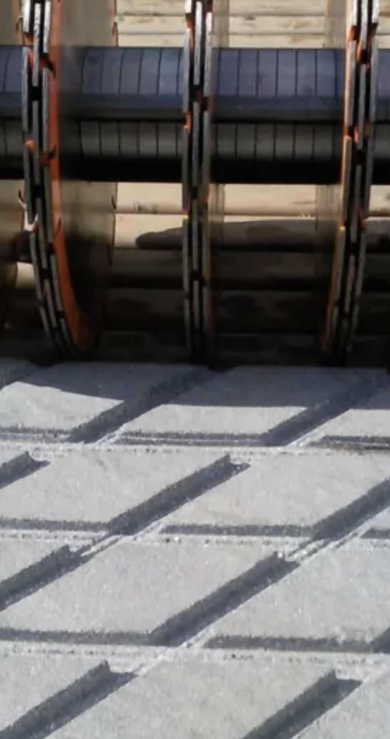 Freshly cut diagonal anti-slip grooves in a concrete dairy yard