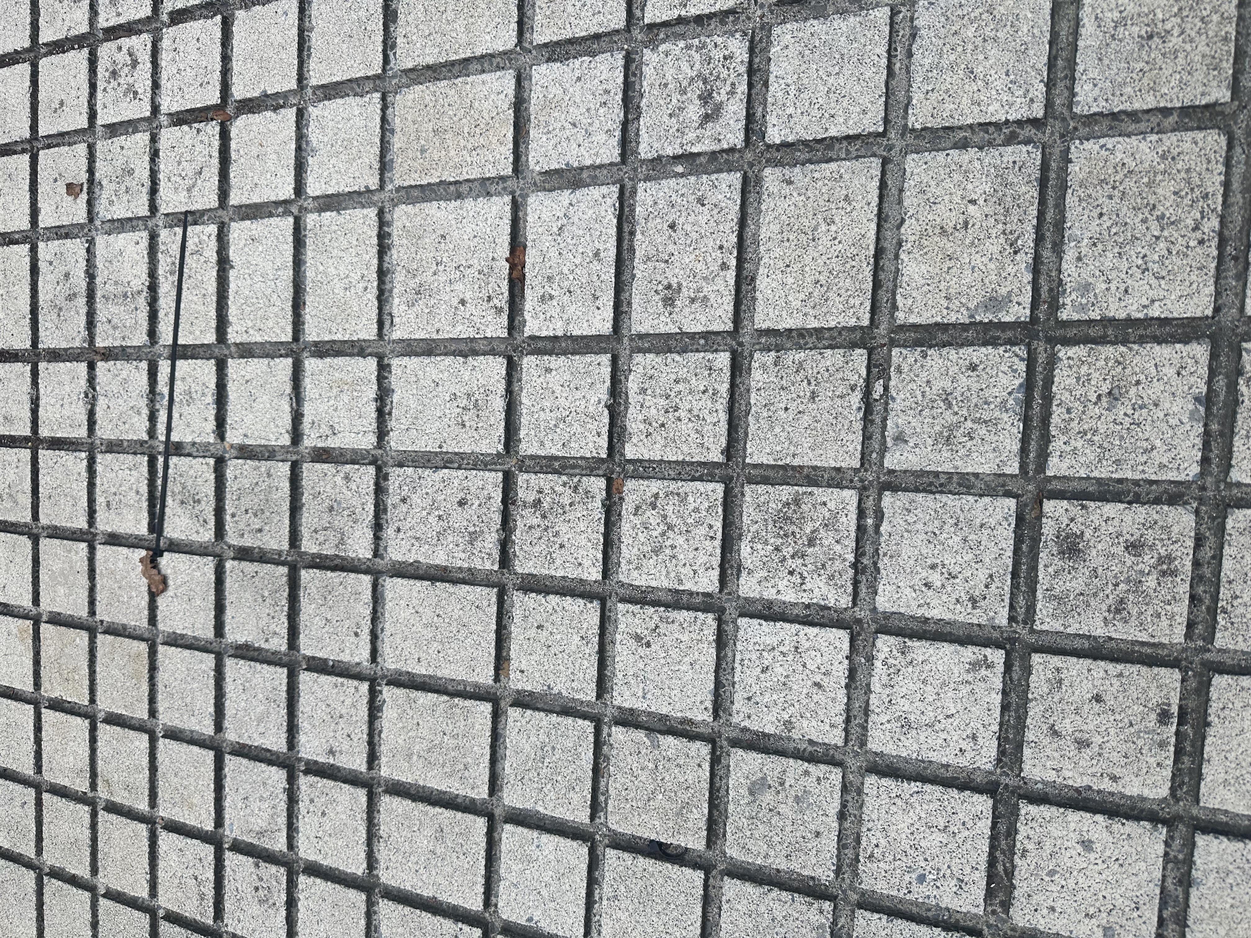 Close-up of square cross-hatch anti-slip grooves cut into concrete