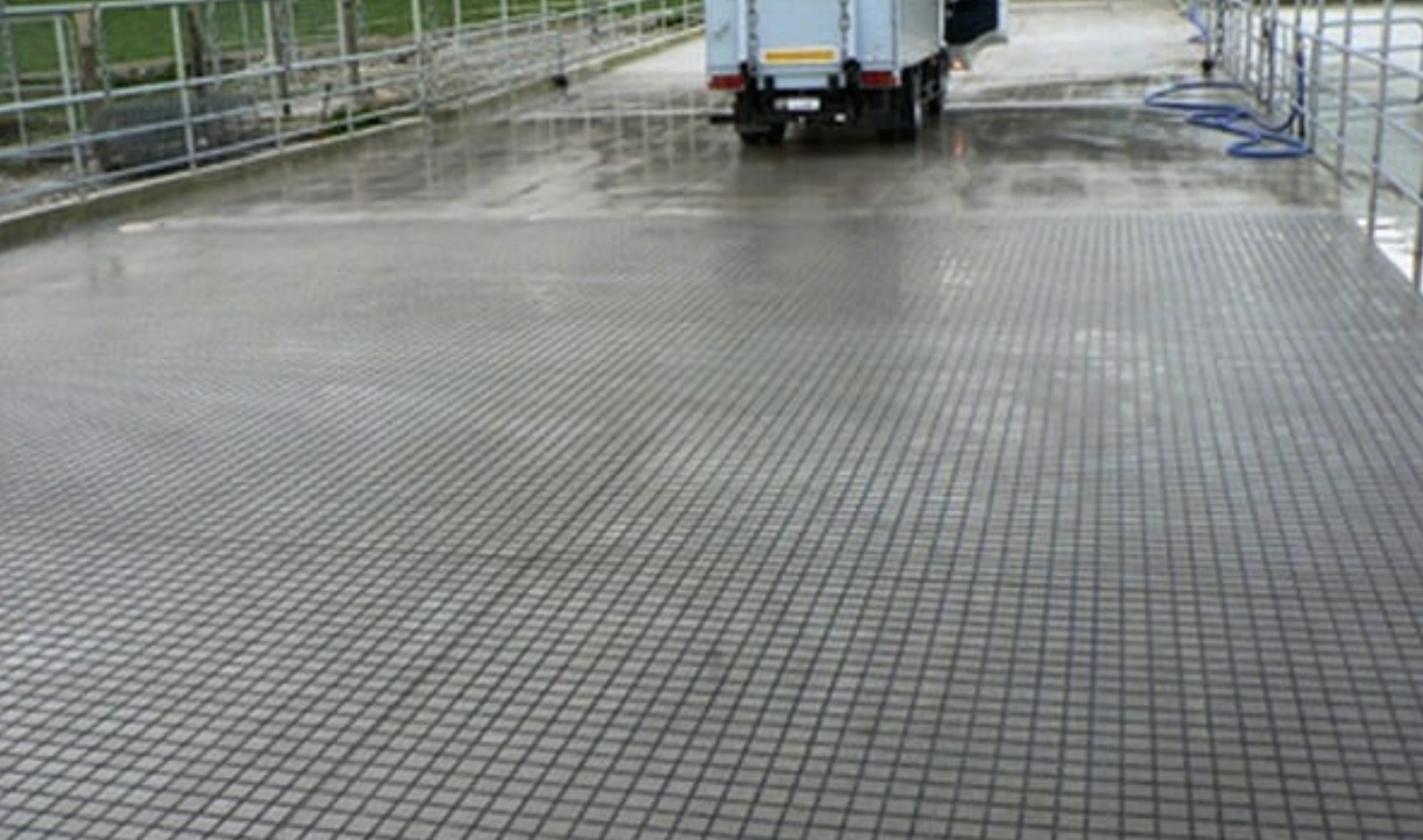 Wet dairy yard with cross-hatch anti-slip grooving draining after a wash down